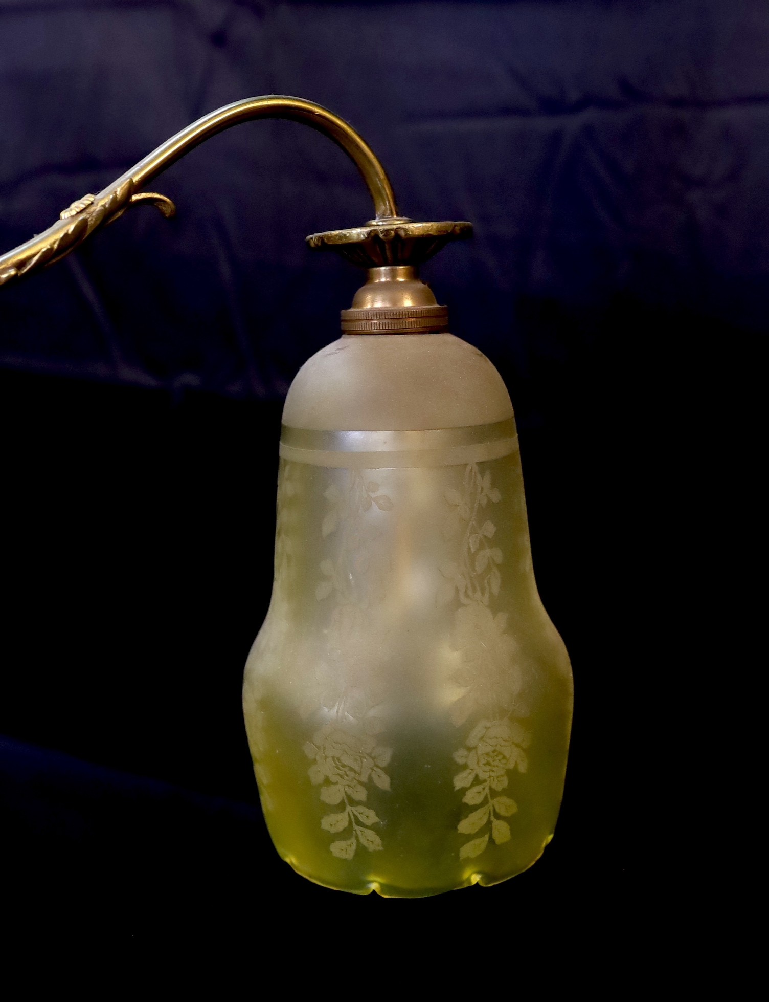 An early 20th century English ormolu counter balanced ceiling light with twin branches, swagged turn centre and yellow tinted frosted glass shades, height from 60 to 120cm